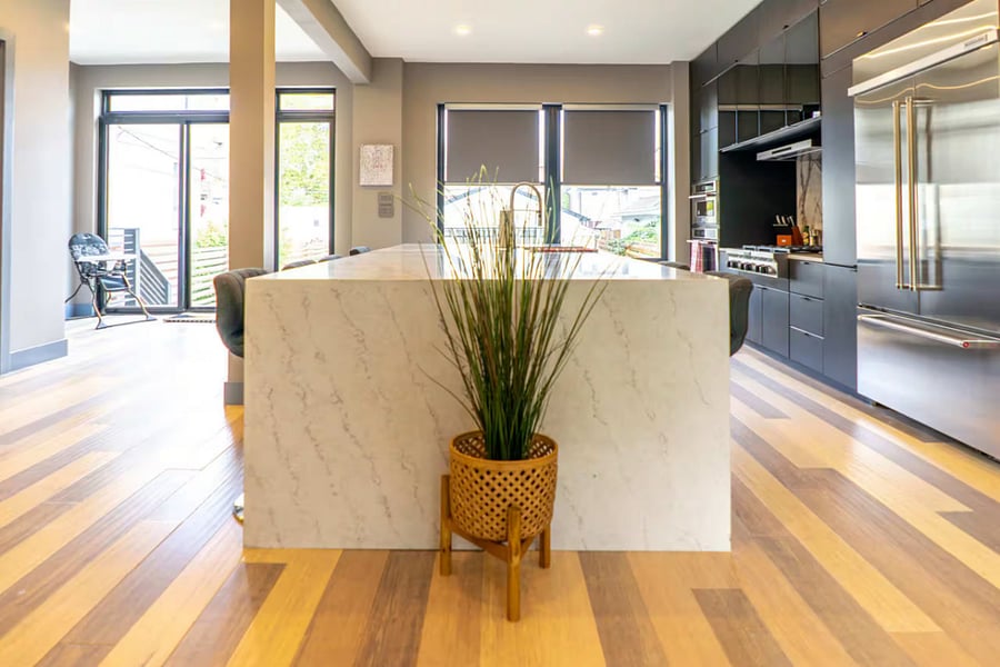 Plush grey bar stools tuck neatly under the marble island for casual dining.