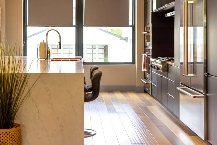 A main-floor hallway shows colorful art, a high chair, and a nearby powder room.