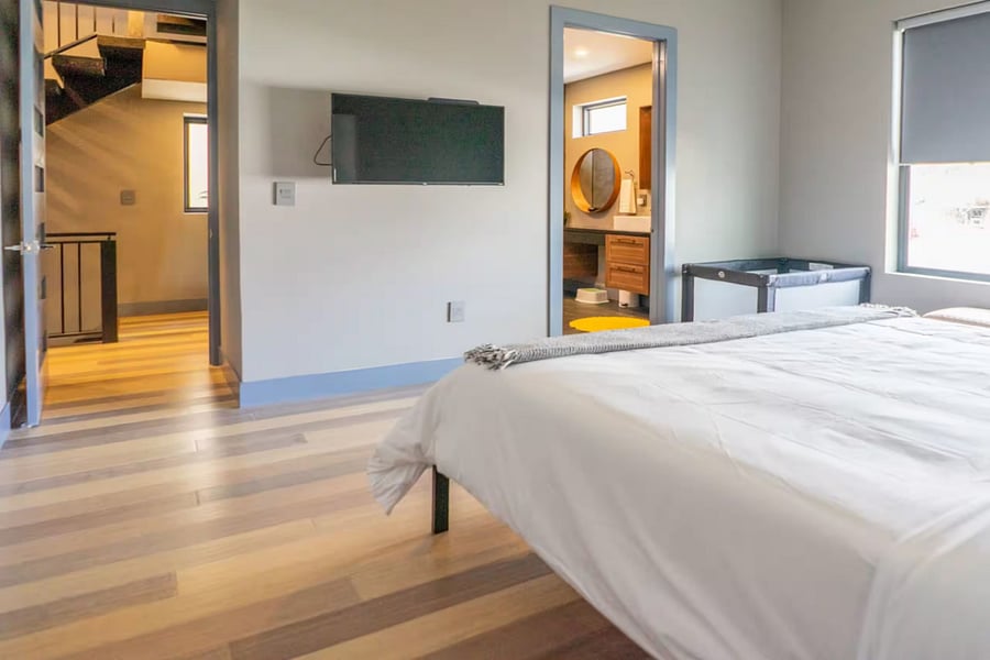 From the sleek walk-in shower, step back into the bright connected bedroom.