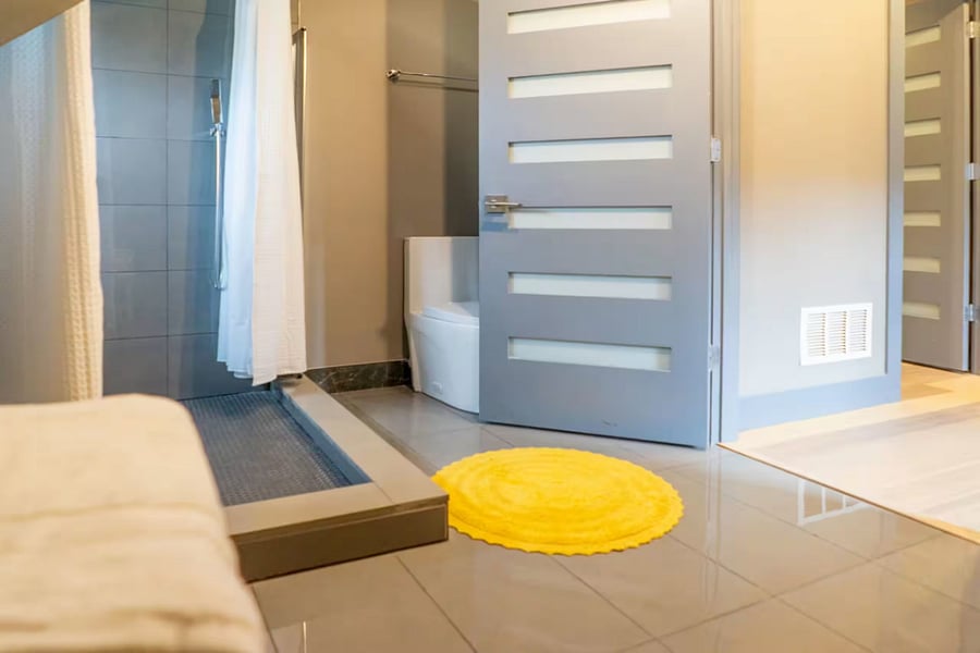 The top-floor landing opens to a bathroom and a bedroom with dresser storage.