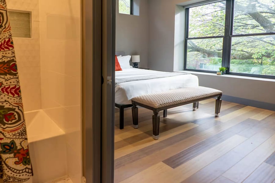 Soft linens and globe lamps make this sloped-ceiling bedroom feel cozy and calm.