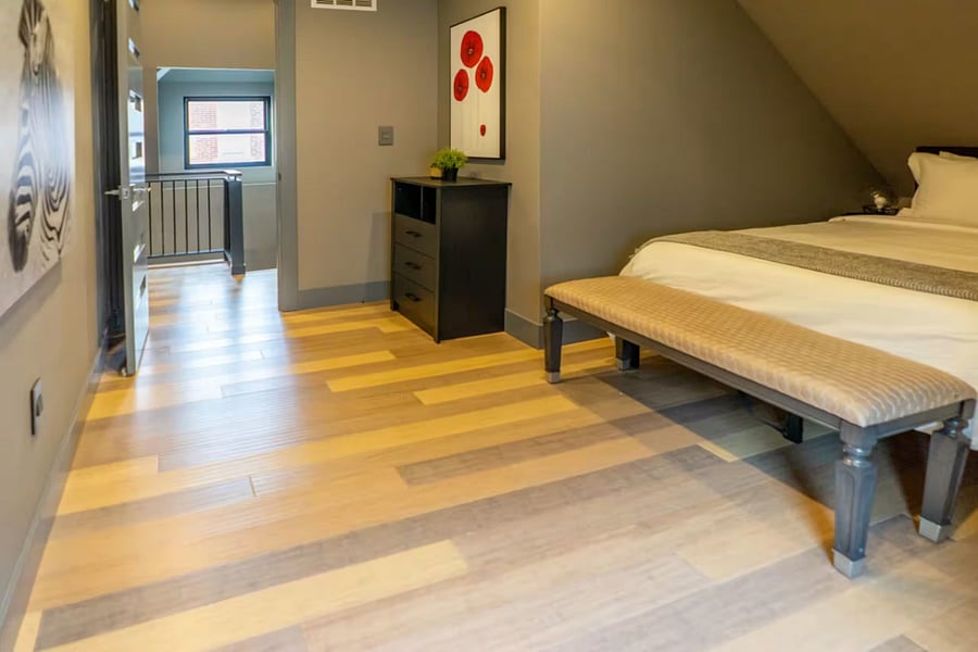 An upstairs bath includes a walk-in shower, modern toilet, and yellow round rug.