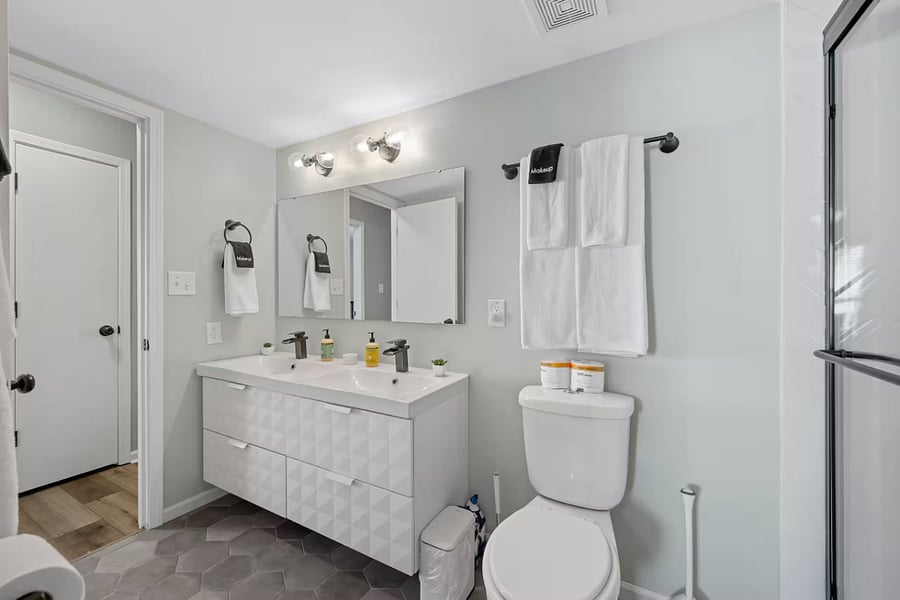 Ample cabinetry and open shelves keep dishes and glassware ready for guests.