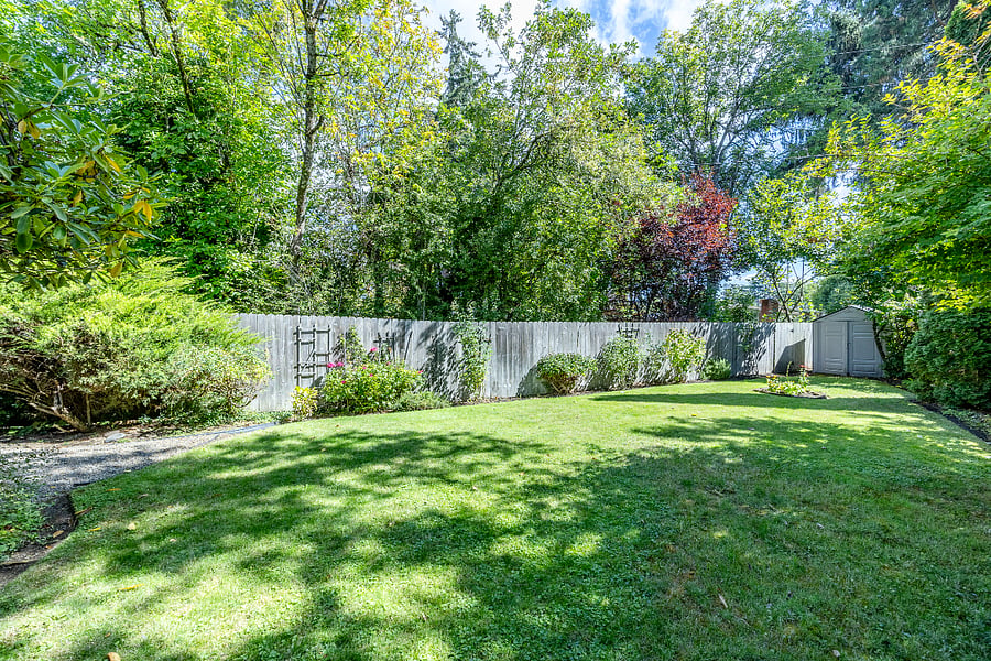 Spacious grassy area with greenery, flowers, and summer garden space. Meticulously cared for. Peaceful and serene! Fully fenced.