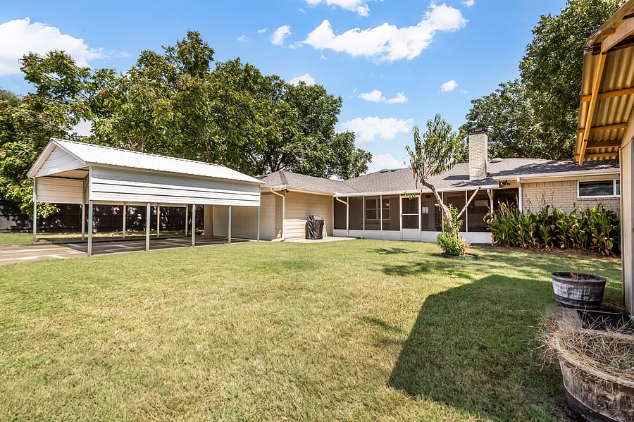 Backyard with carport for two cars.