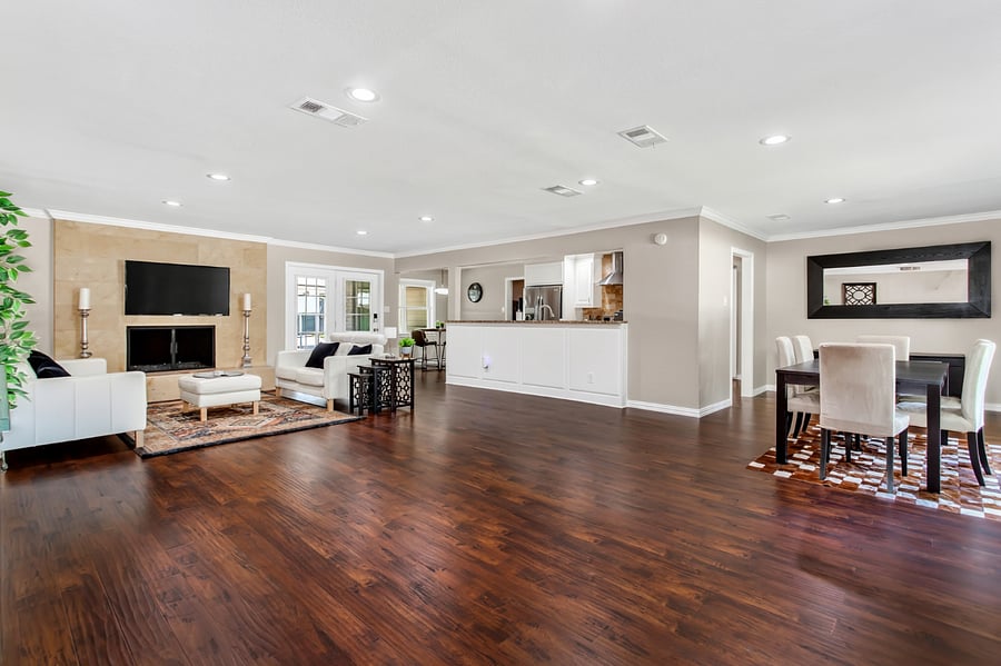 Open plan living room with leather sofas and a 55inch smart TV.