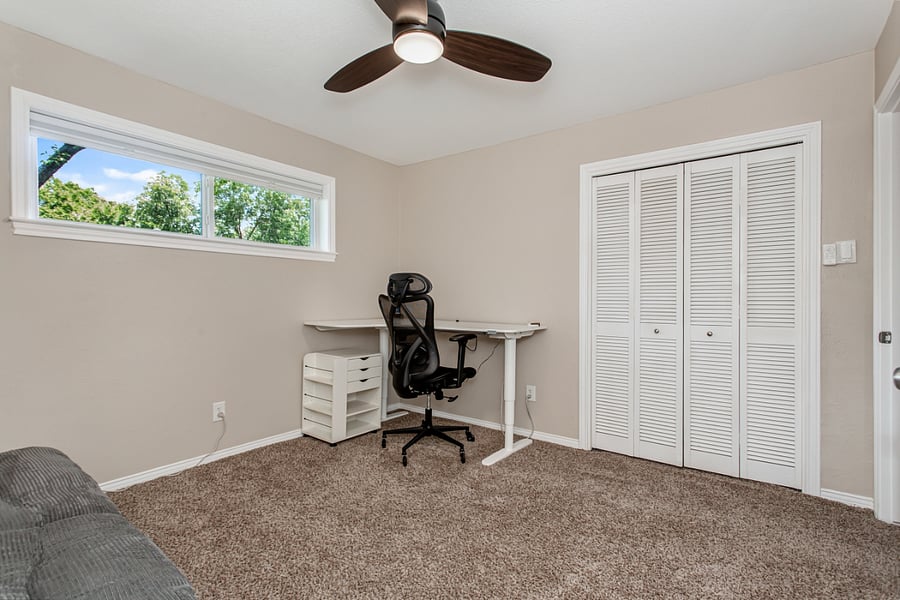 Office with futon and desk.