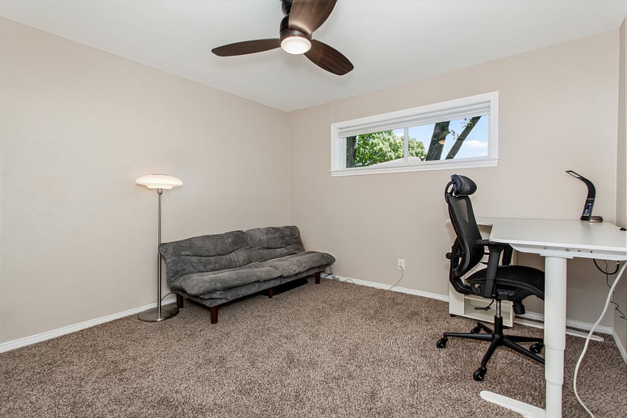 Office with futon and desk.