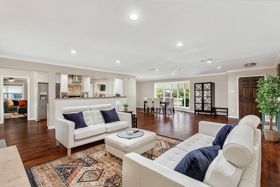 Open plan living room with leather sofas and a 55inch smart TV.