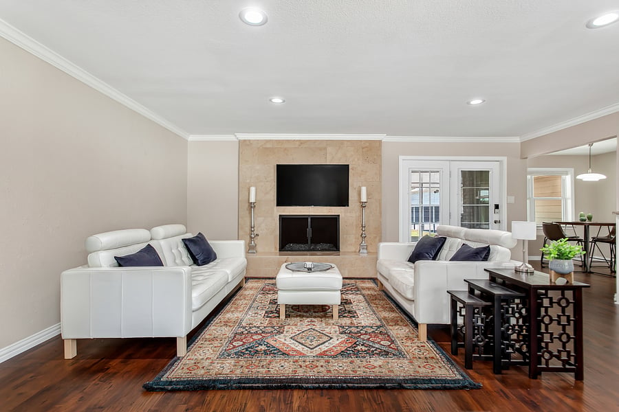 Open plan living room with leather sofas and a 55inch smart TV.