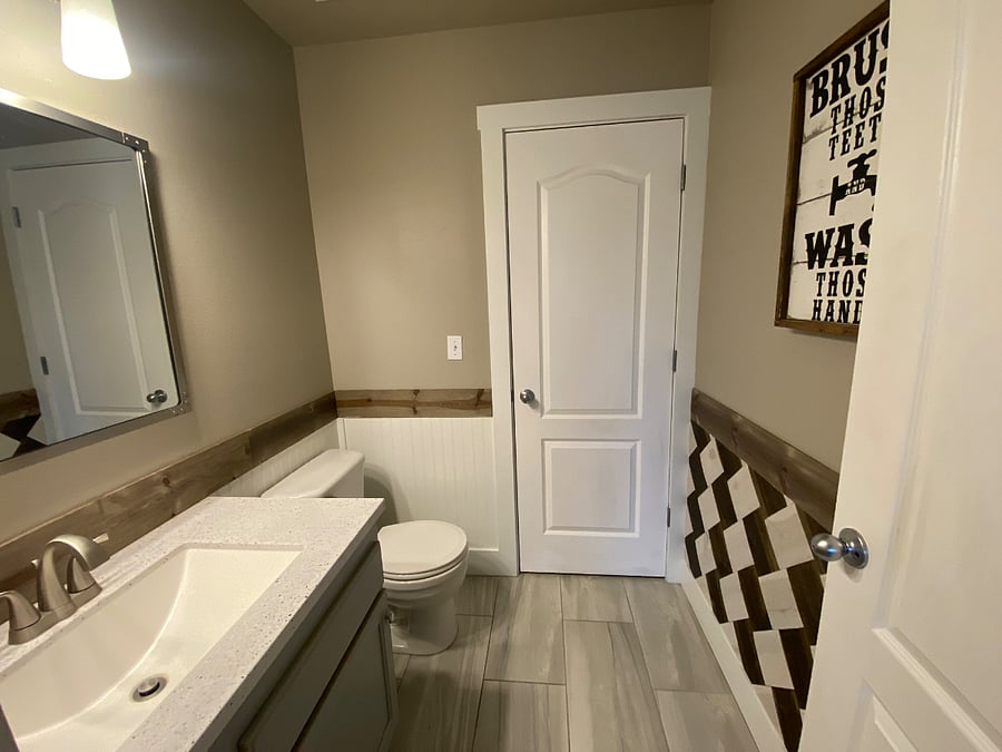 Downstairs bathroom between Downstairs bedroom and main living room.