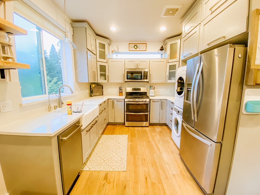 fully stocked kitchen with full size fridge, double oven, microwave, dishwasher, washer/dryer