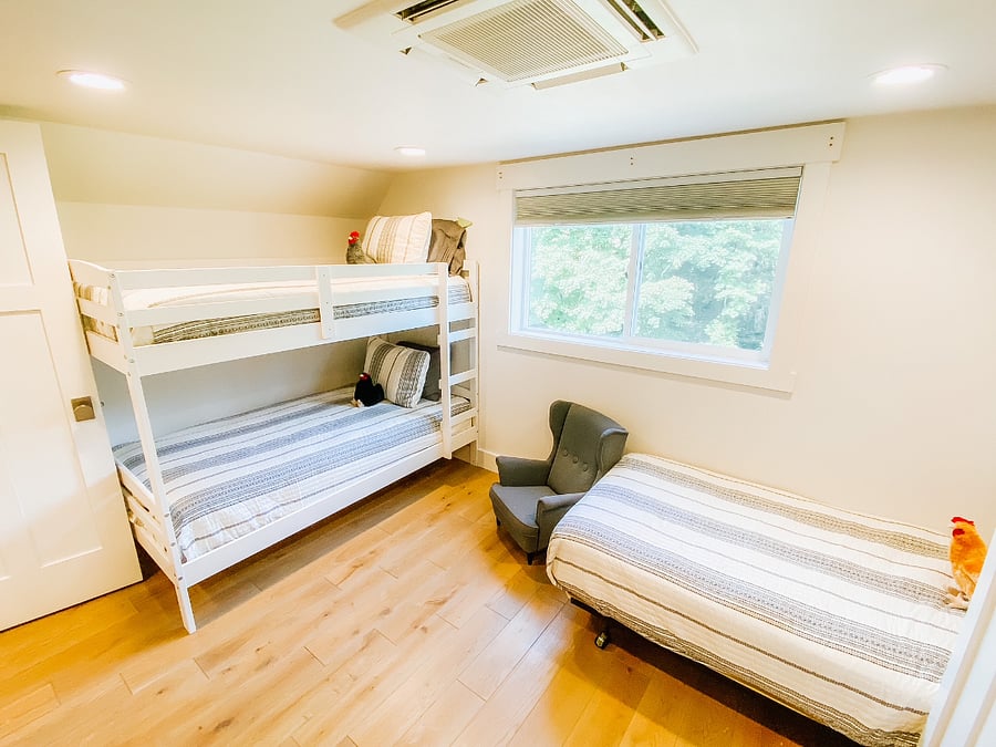 upstairs bunkroom with twin bunkbeds and single twin bed