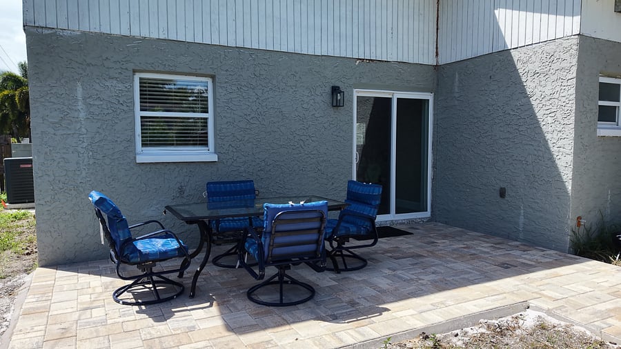 Outdoor dining area directly off the kitchen slider with double wide paver path to covered Gazebo area.