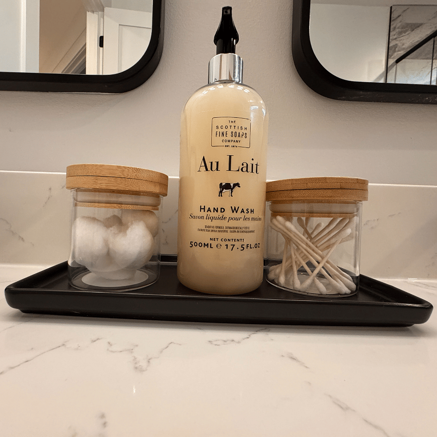 Starter hand soap in each bathroom. (refillable container)
