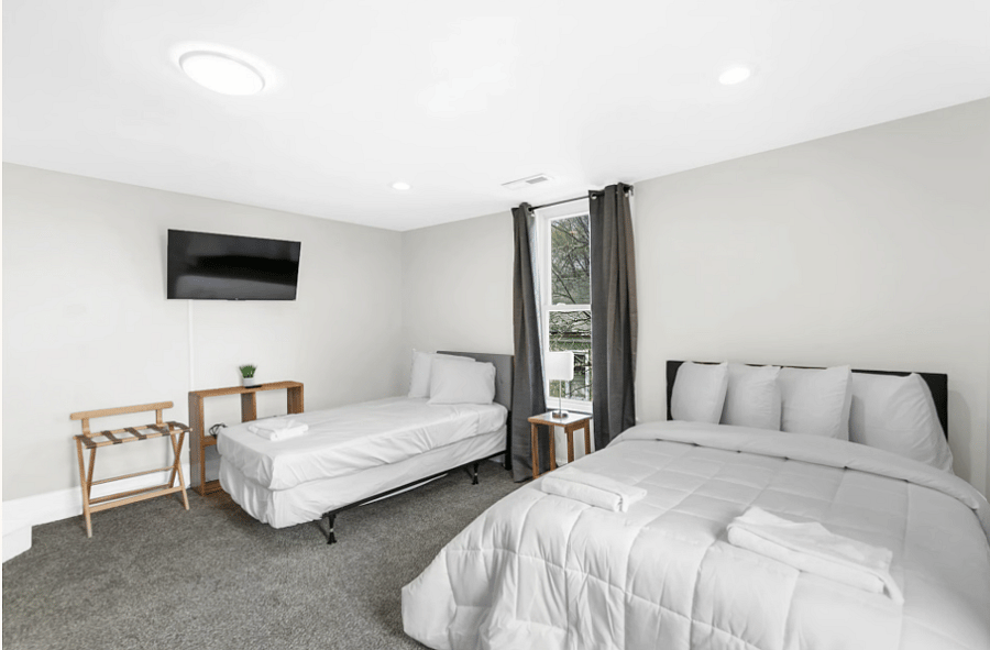 This bedroom features a full bed and a twin bed, offering a flexible setup that works well for both kids and adults.