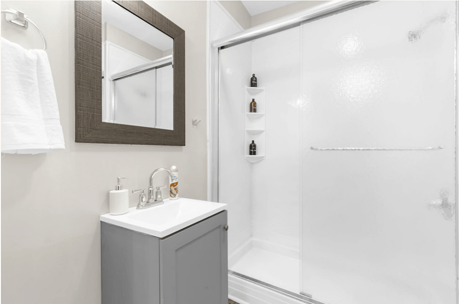 The upstairs bathroom features a clean, functional layout with a walk-in shower, conveniently located near all upstairs bedrooms.