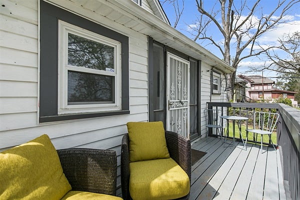 A quiet spot to unwind, the back porch offers a relaxed outdoor setting with comfortable seating, perfect for morning coffee or winding down in the evening.