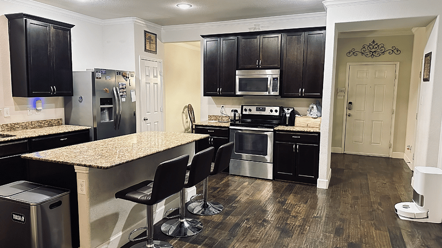 Fully stocked kitchen with granite island and stainless appliances