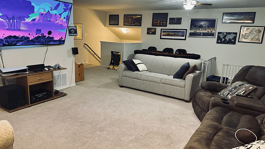 Game room with smart TV, sleeper sofa, and work desk