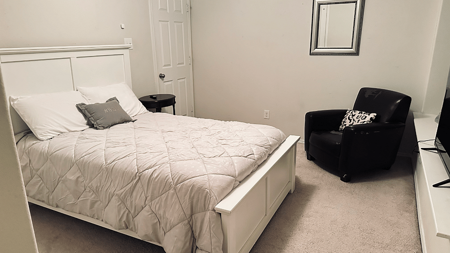 Upstairs bedroom with smart TV and blackout curtains