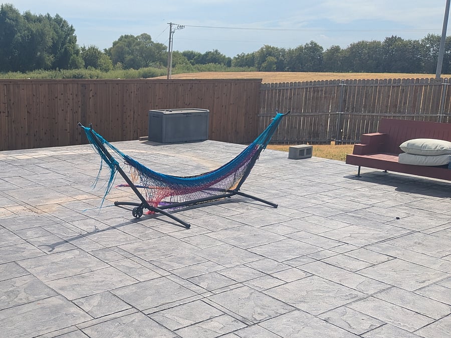 Large stamped-concrete patio in a fully fenced backyard