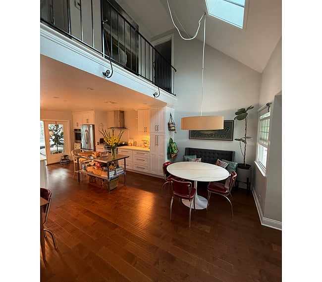 Gourmet Kitchen & Dining: A large, modern, well-equipped kitchen featuring premium KitchenAid appliances and a spacious dining area. This is a shared space.