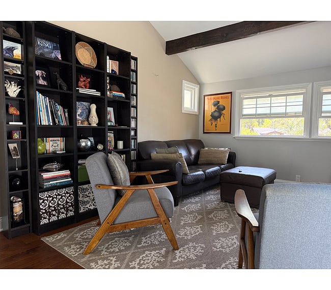 Bonus Entertainment Lounge: Includes a leather couch & ottoman, 2 accent chairs, vaulted ceiling, a chandelier/lamp, smart TV, stereo, and a variety of books.