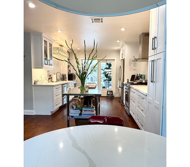 Bright, spacious, modern, well-equipped kitchen featuring microwave, gas range/stove, electric convection ovens, dishwasher, KitchenAid mixer, Breveille food processor. Use of kitchenware, utensils, kitchen linens. This is a shared area.