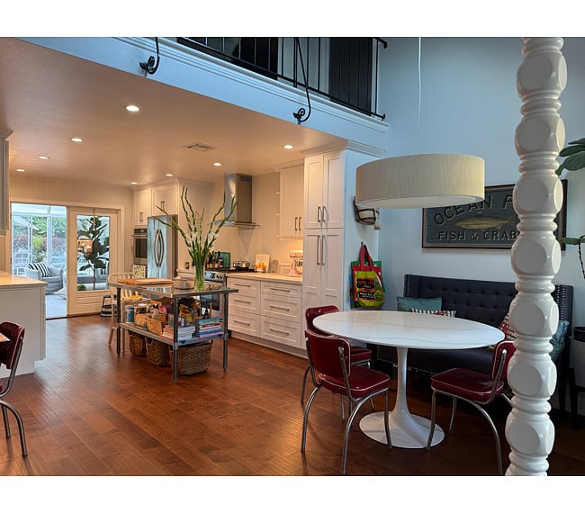 French doors at end of kitchen open to glass, screened sunroom. Garage entry via sunroom. In the garage you will find front loading washer & dryer and shared fridge. These are shared spaces.