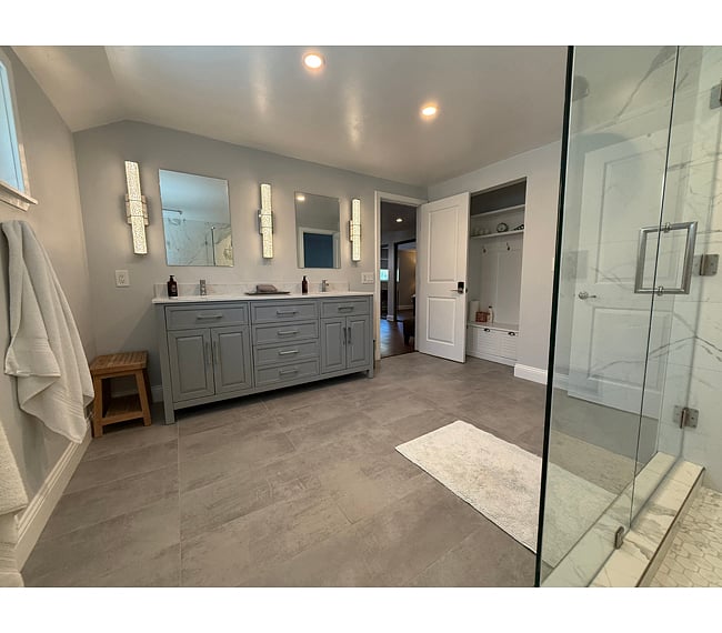Double vanity with extensive storage. Dedicated linen storage.