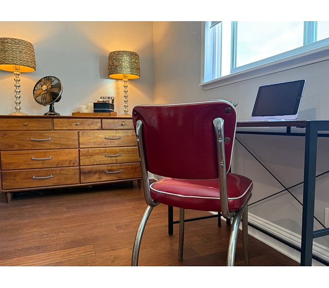 9-Drawer walnut chest, workspace. Window has tree and canyon views.