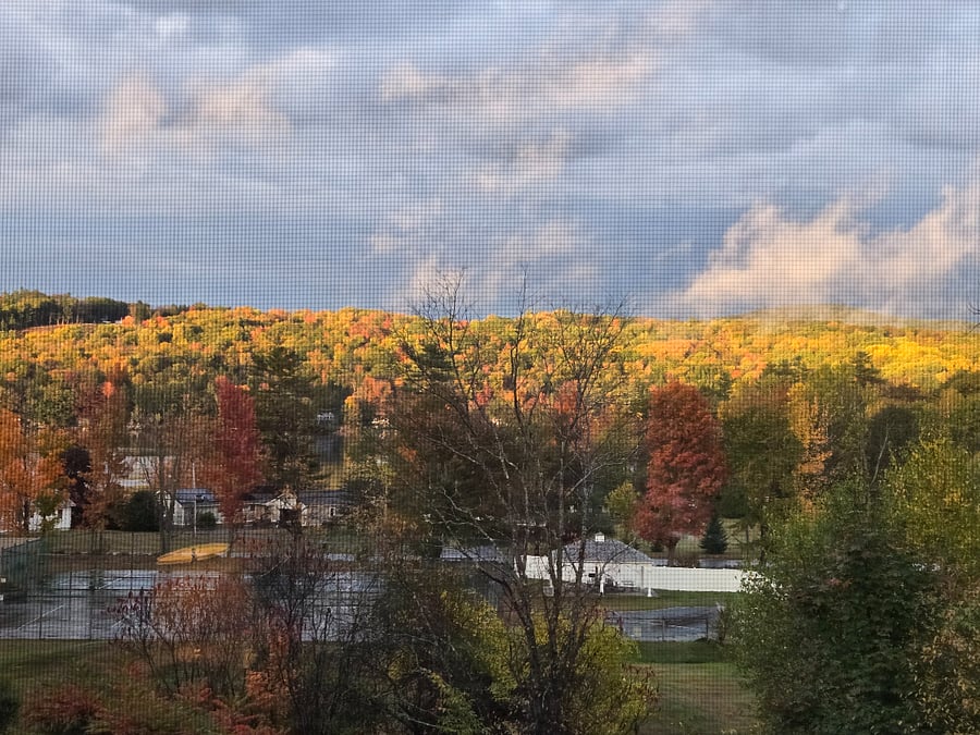 The view of the pool with pavilion, tennis courts, and Lake Mascoma.