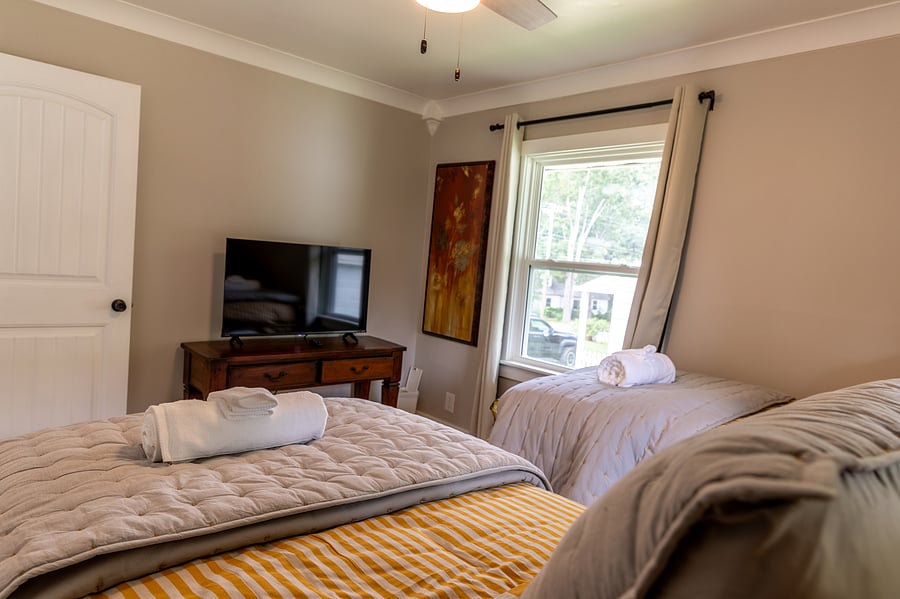 twin bed room with TV