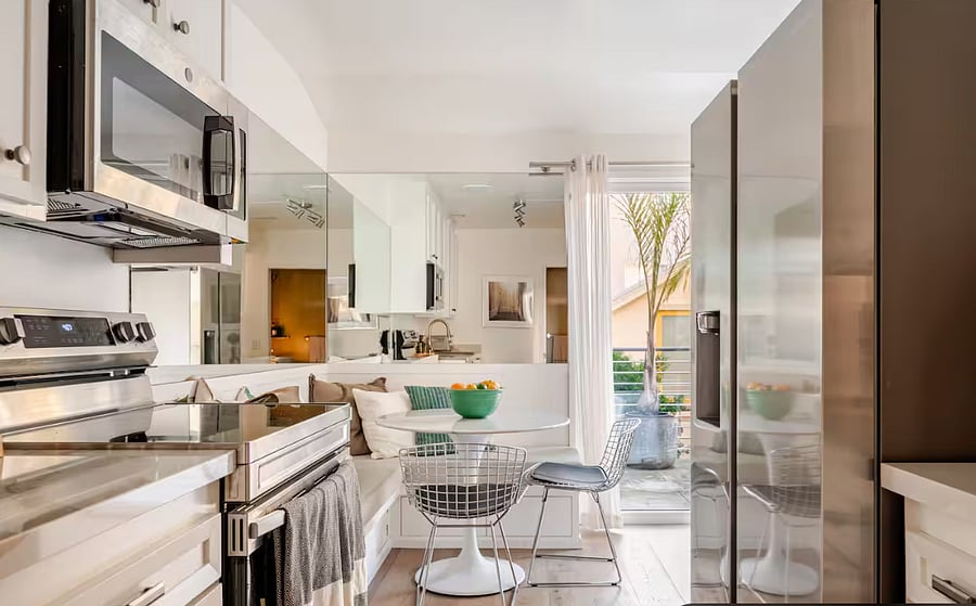 Well stocked, light infused kitchen with induction stovetop, large fridge/freezer, small air fryer, microwave, dishwasher, blender, and tons of plates/bowls/glasses/utensils and cooking utensils.