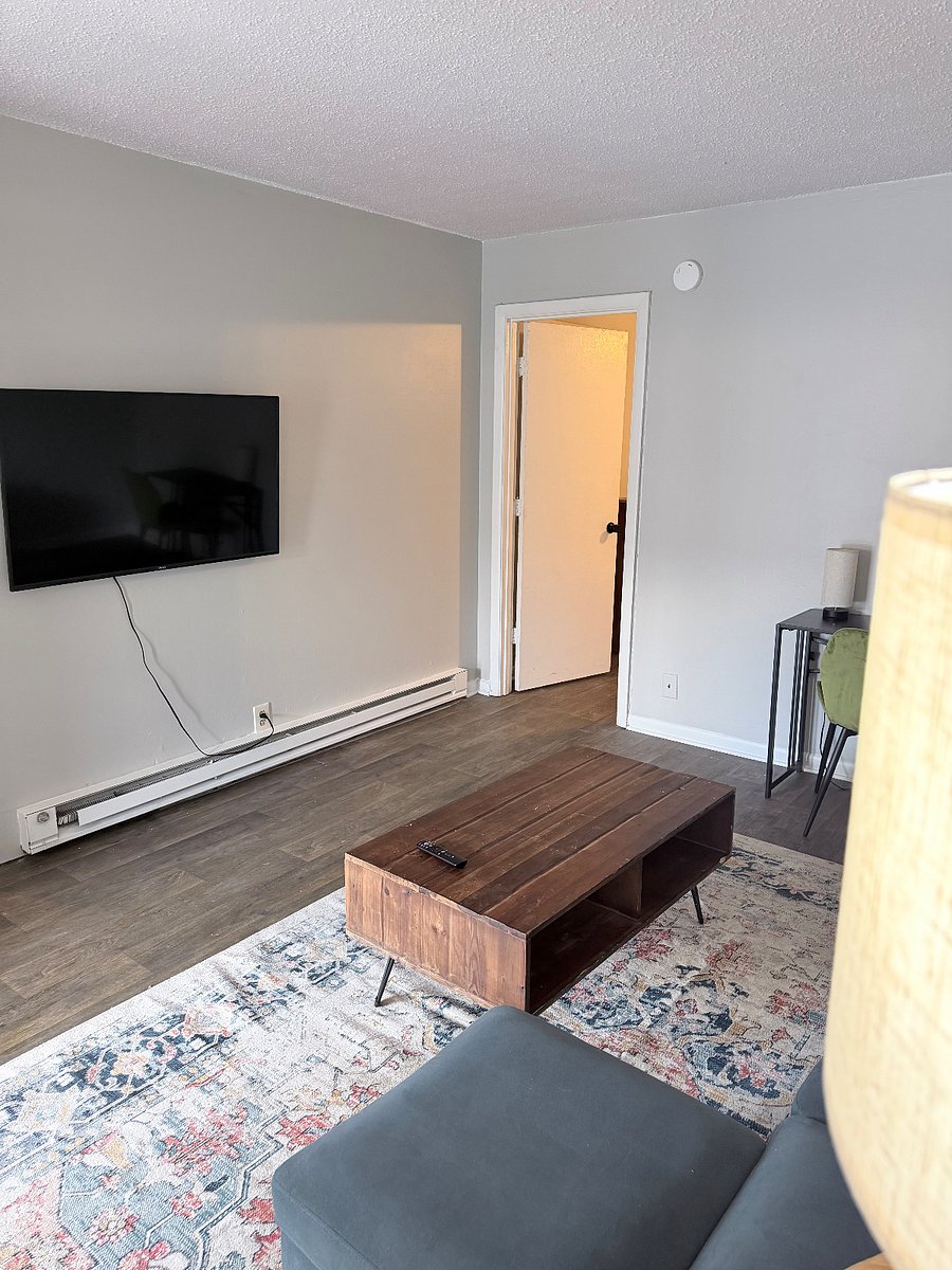 Wall-mounted smart TV and comfortable sectional for evenings at home