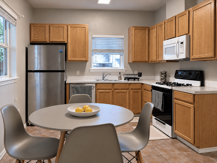 Full kitchen with table and chairs, fully stocked