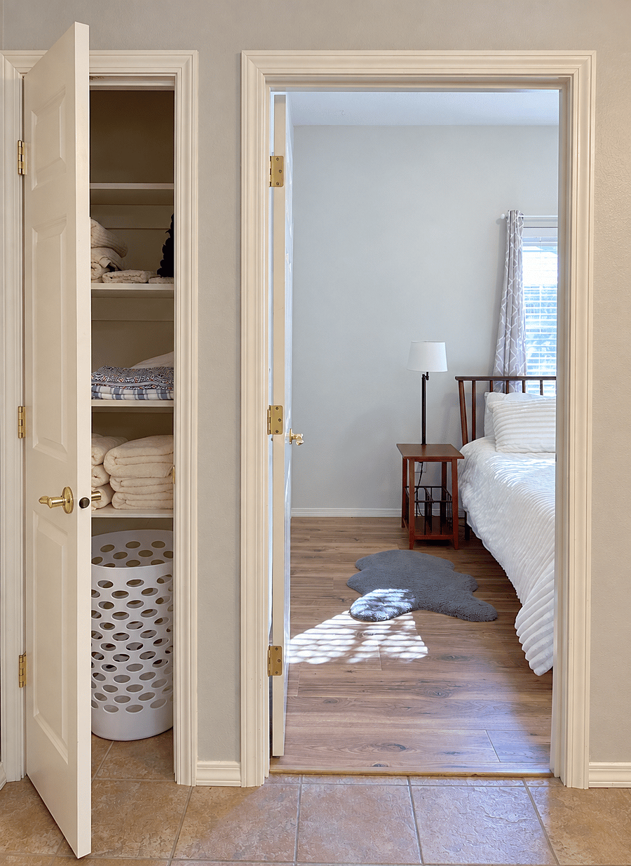 Stocked linen closet with additional towels, sheets, and laundry hamper, plus space for you to store your things, next to the bedroom