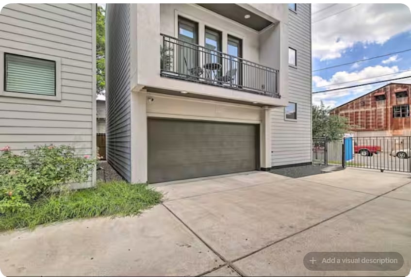 Private two-car garage with a wide driveway for convenient off-street parking.
Gated access adds privacy, while the upper-level balcony provides additional outdoor space overlooking the parking area.