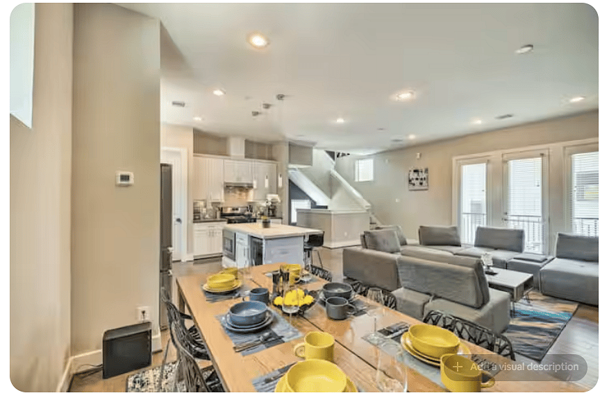 Open-concept dining, kitchen & living area designed for gathering.
Large dining table offers generous seating, while the kitchen island adds casual seating.
Spacious sectional, bright windows & open layout create an inviting shared space.