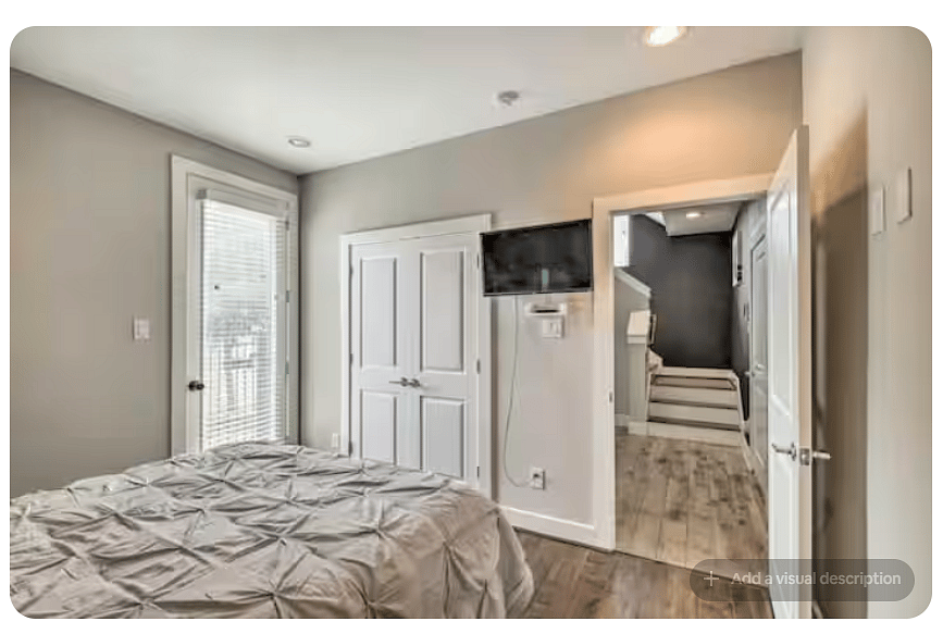 Comfortable bedroom with warm wood floors, built-in closet storage & wall-mounted TV.
A glass door brings in natural light and provides outdoor access.
Clean, modern finishes and easy hallway access complete the space.