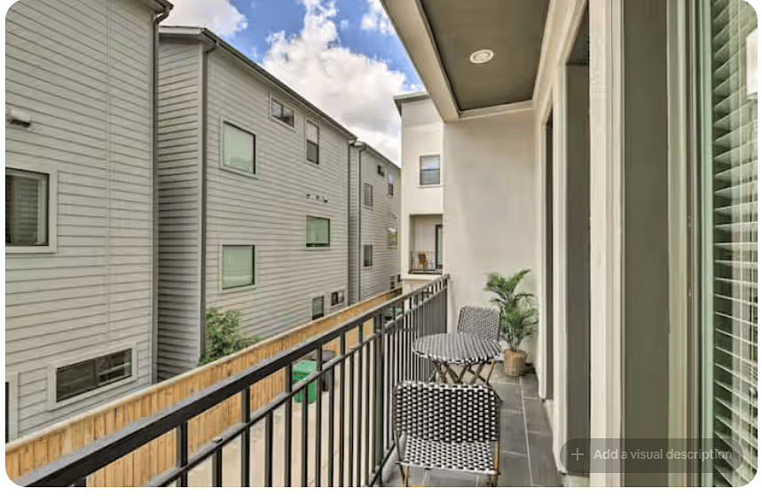 Private covered balcony with outdoor seating for twoperfect for morning coffee or fresh air.
Bistro-style table and chairs create a simple outdoor retreat, while the railing and overhead cover define the cozy space.