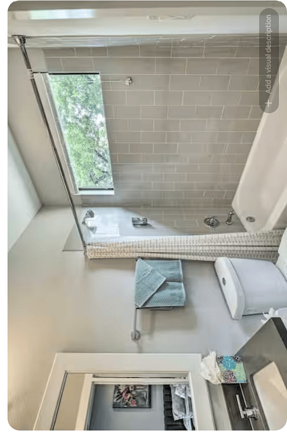 Bright full bathroom featuring a tub/shower combination with modern tile surround.
A wide privacy window brings in natural light, while the vanity, large mirror & clean contemporary finishes create a fresh, functional space.