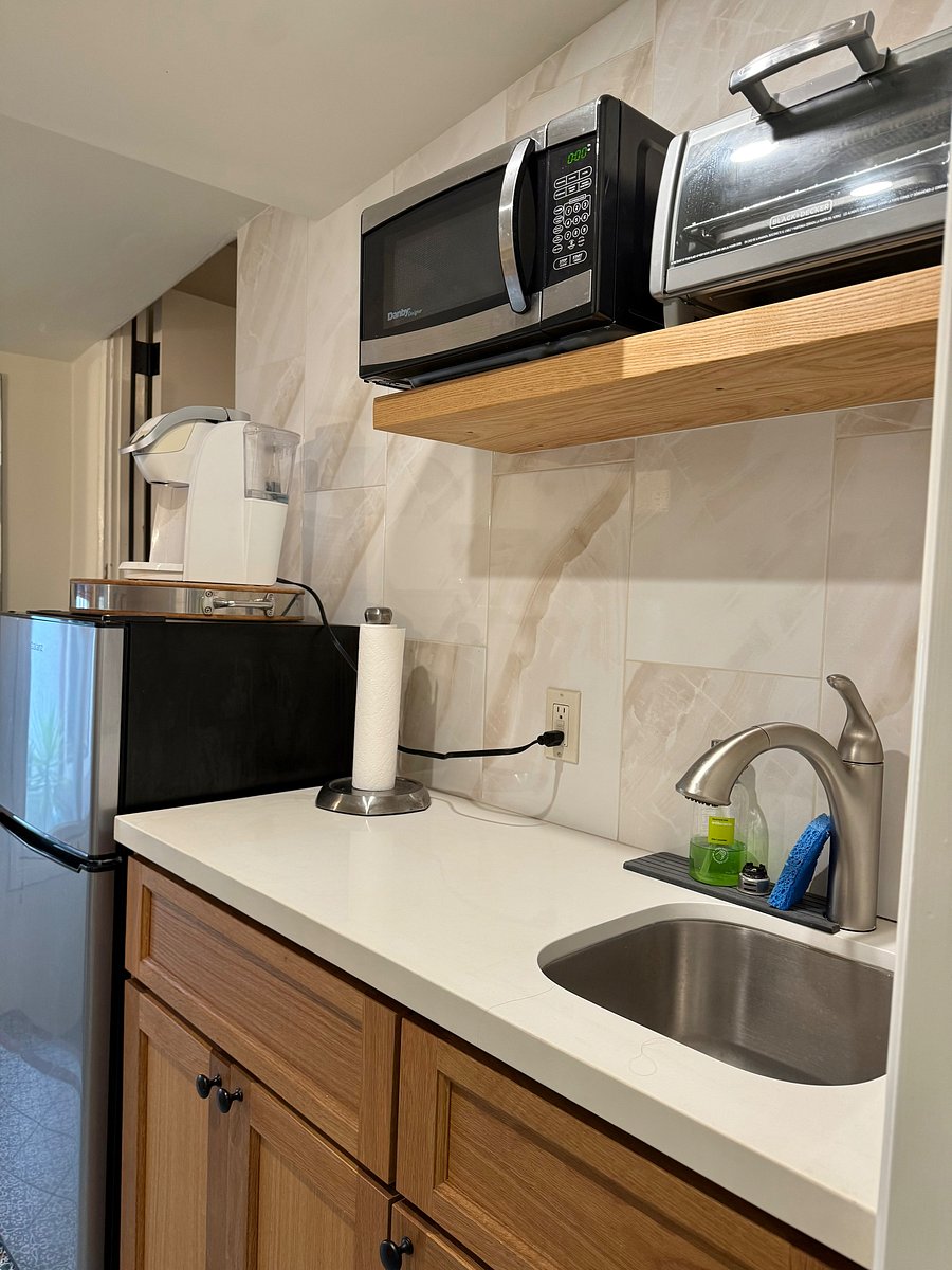 Kitchenette-small fridge/freezer, microwave, toaster oven, Keurig coffee maker, small sink w/spray faucet. Open shelving w/lower cupboard for storage