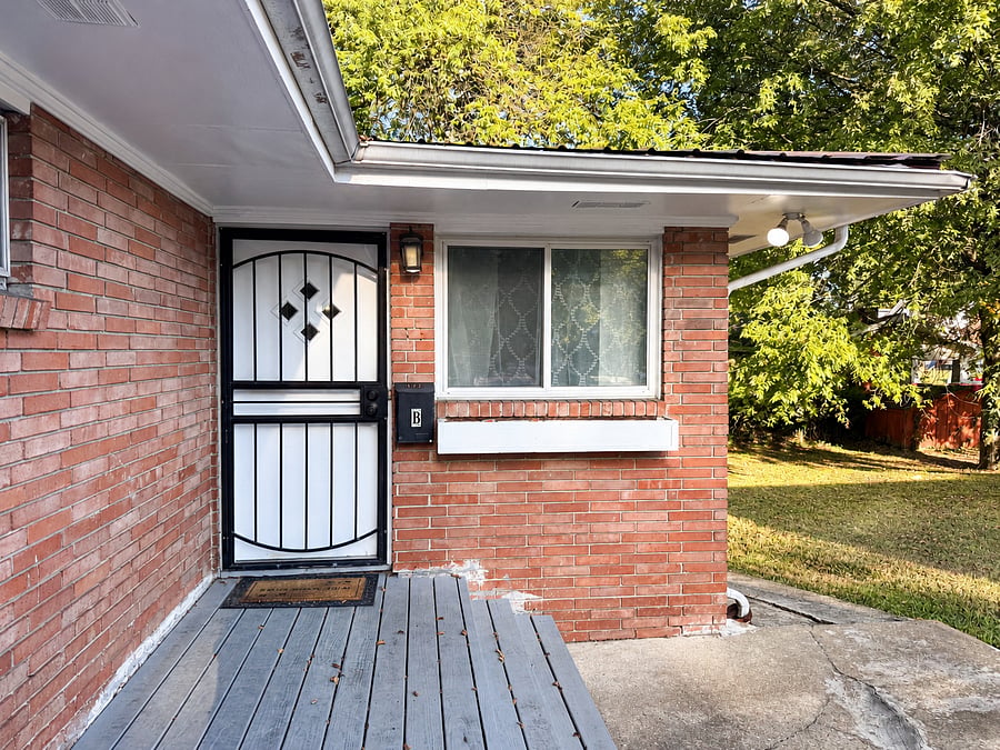 Front door view, with neighboring apartment within duplex.