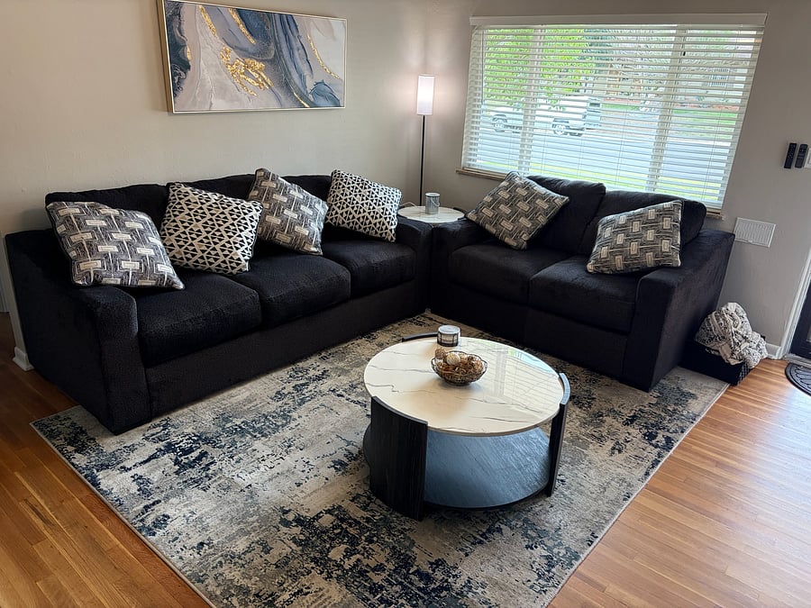 Brand new furniture with pillows and blankets creating space for you to cozy up after a long day.
