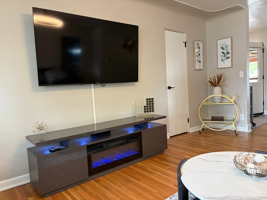 Electric fireplace with adjustable flame colors creates the look of a real fire, with a built-in heater for extra warmth when you want it.