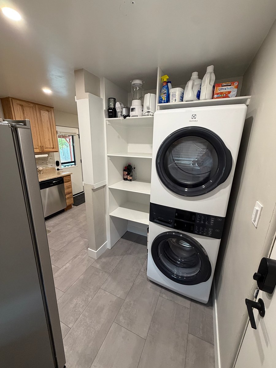 Brand new washer/dryer with detergent, fabric softener (liquid and sheets), and stain treatment provided.
Storage shelves provide additional kitchen storage for small appliances and pantry items. Olive oil, vinegar, and basic seasonings provided.