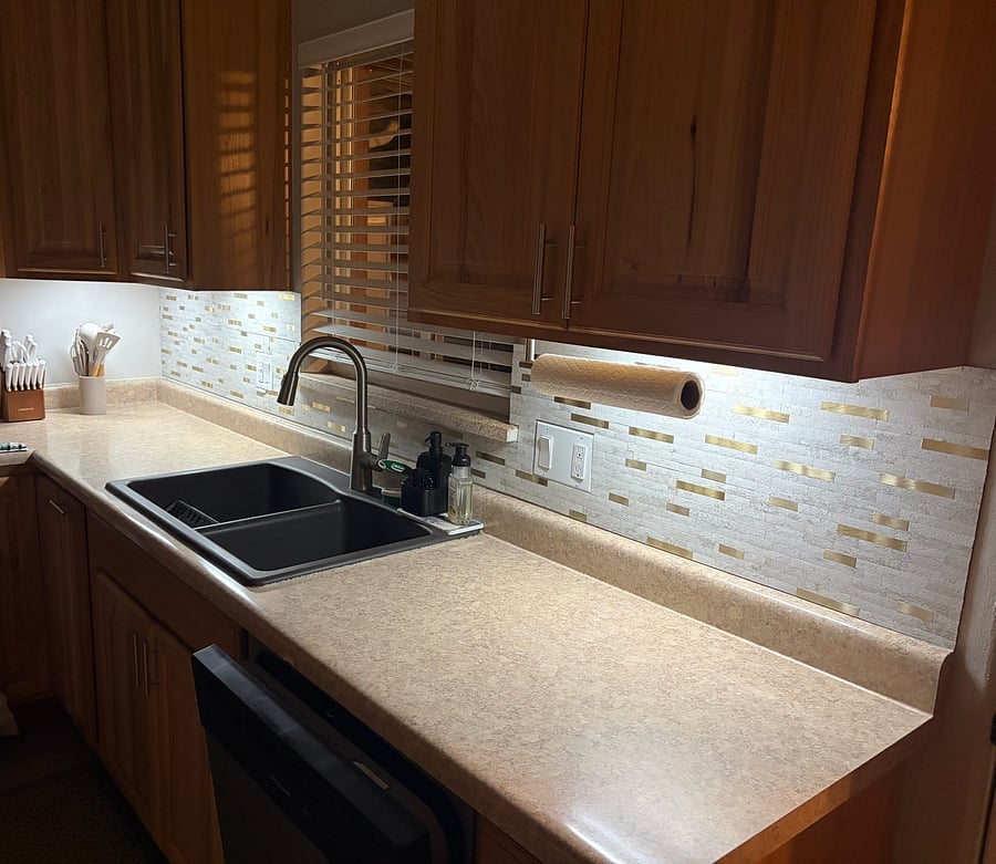 Motion-activated under cabinet lighting keeps the kitchen bright and easy to navigate.