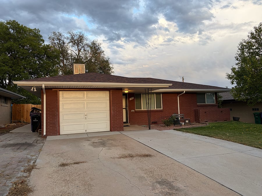The extra wide driveway provides parking for up to three cars side by side.